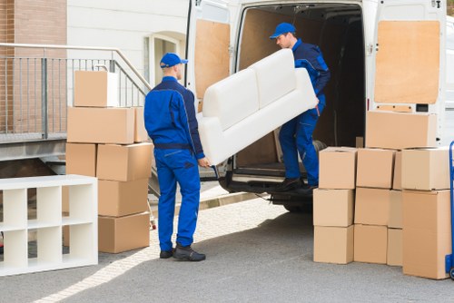Removal team handling flat furniture in Ilford